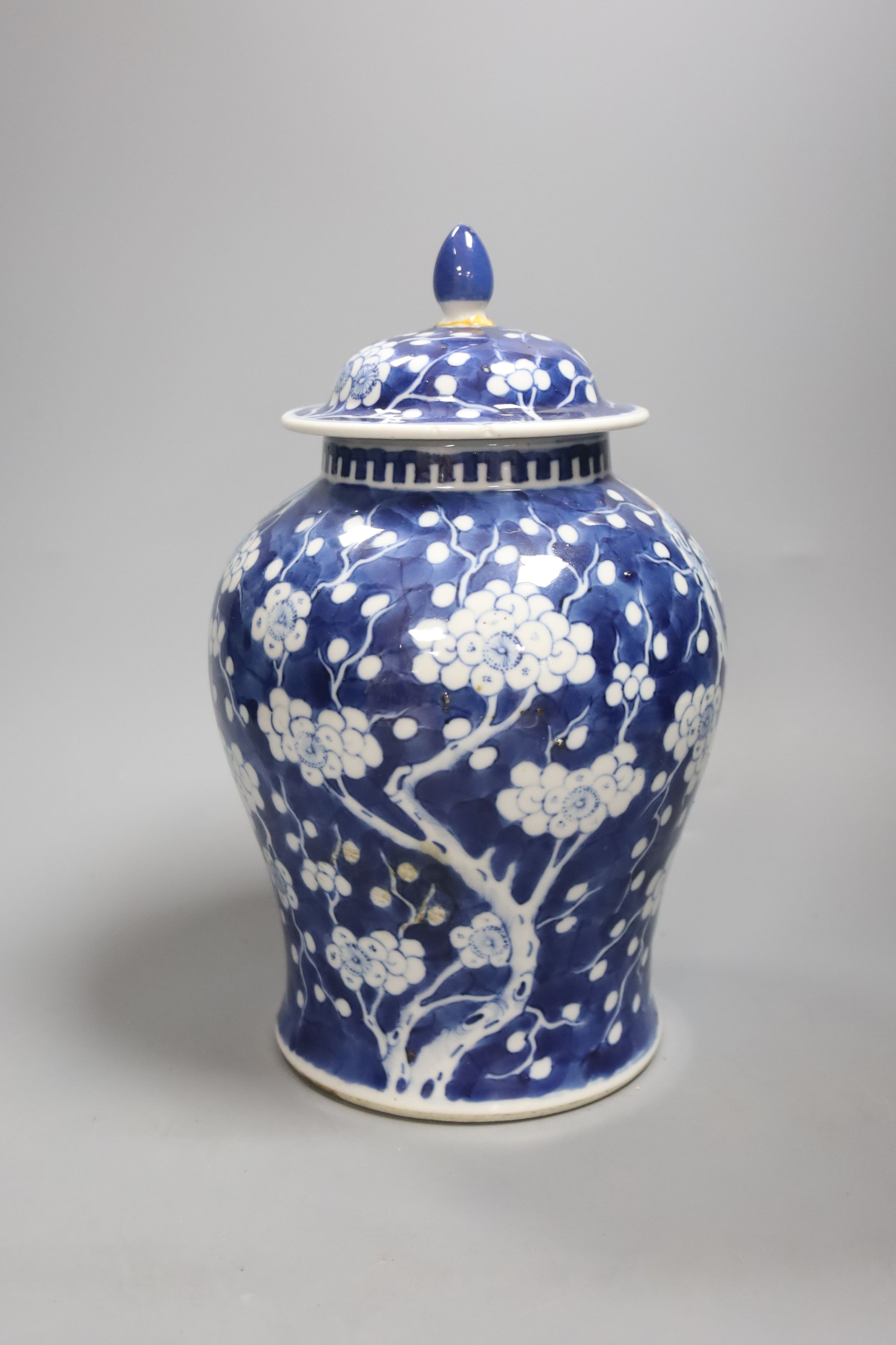 A 20th century Chinese blue and white jar and cover with prunus decoration, height 25cm